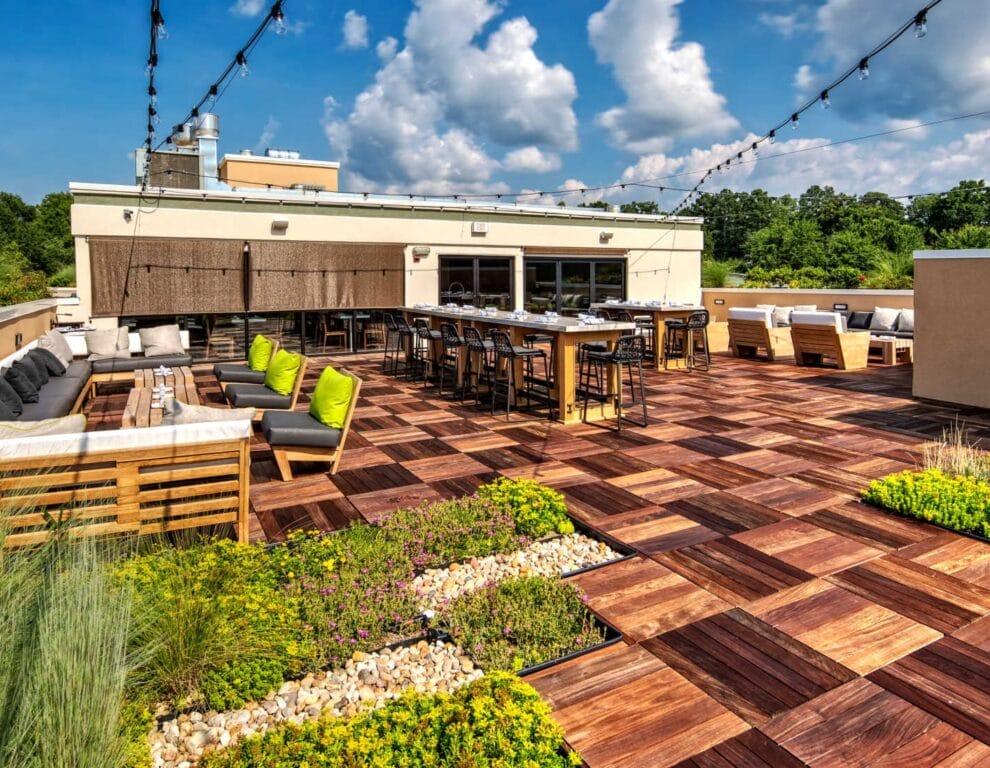 A rooftop terrace featuring GreenGrid Roofs modular garden planters, wooden decking, and outdoor lounge seating at the Marriott Hotel.